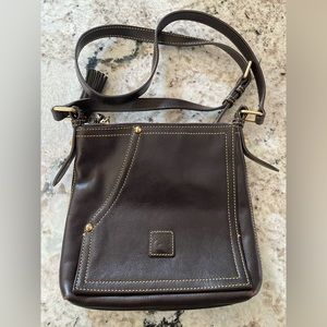 Dooney & Bourke. Brown leather cross body. 10”L x 2”W x 9”H.